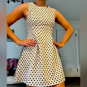 Ivory dress with black arrow designs.